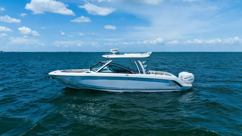 Slide: The Image of Side Profile of 320 Vantage The 2019 Boston Whaler 320 Vantage is showcased in this side profile, highlighting its sleek design and robust build. The vessel features a stylish hardtop and spacious deck area, perfect for both leisure and adventure. Powered by dual engines, this model - 7469846