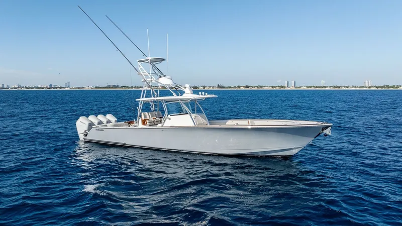 Slide: The Image of Starboard Profile of V-41 The Valhalla V-41 showcases its sleek starboard profile against a serene ocean backdrop. This 2025 model is equipped with powerful quad outboard engines, ensuring superior performance and speed. Its elegant design features a spacious deck, perfect for bot - 7517270