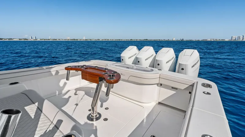 Slide: The Image of Stern with Fishing Station and Engines This image showcases the stern of the 2025 Valhalla V-41, featuring a well-equipped fishing station complete with rod holders and a polished wood table. The sturdy deck offers ample space for angling activities, while the four powerful outboard engines en - 7517245