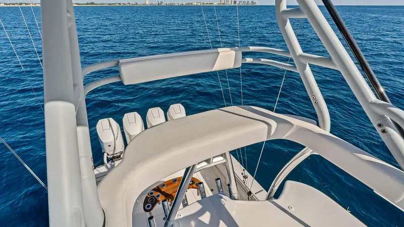 Slide: The Image of Flybridge Helm Station View The flybridge of the 2025 Valhalla V-41 offers an elevated vantage point, showcasing an ergonomic helm station with advanced controls. Sleek design and premium materials provide both functionality and comfort, while the surrounding safety rails ensure sec - 7517266