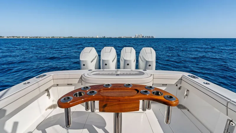 Slide: The Image of Aft Deck with Fishing Rod Holders The aft deck of the 2025 Valhalla Boatworks V-41 is designed for the avid angler, featuring a beautifully crafted wooden rod holder with multiple slots. The clean, spacious layout ensures easy movement, while the powerful quad outboard engines promise exc - 7517260