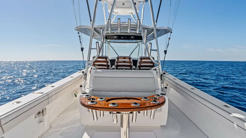 Slide: The Image of Cockpit with Helm and Seating The image showcases the spacious cockpit of the 2025 Valhalla V-41, featuring a helm station with plush seating. High-quality materials and a sleek design enhance the functional layout, perfect for both fishing and leisure. The polished wood accents and i - 7517244