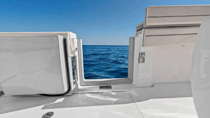 Slide: The Image of Transom Entry with Ocean View This image showcases the sleek transom entry of the 2025 Valhalla V-41, offering seamless access to the azure waters. The polished surfaces and modern lines enhance the vessel's sophisticated aesthetic, while the clear view to the open sea invites endless - 7517263