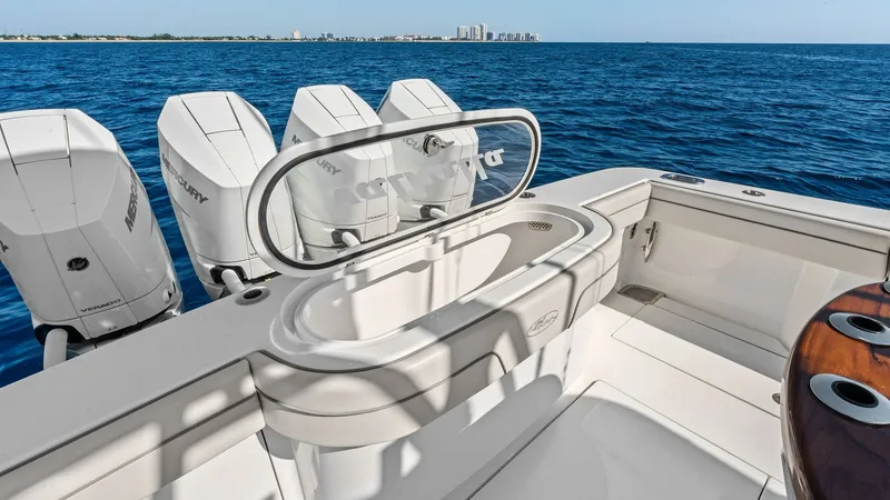 Slide: The Image of Aft Deck with Livewell and Engines The aft deck of the 2025 Valhalla V-41 features a well-equipped livewell, ideal for fishing enthusiasts. The spacious area is complemented by a sleek, integrated design that includes cutting-edge Mercury outboard engines, ensuring powerful performance on - 7517262