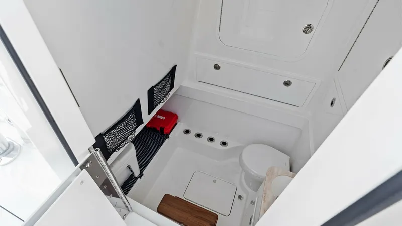Slide: The Image of Compact Head Compartment The well-equipped head compartment on the Annabee V-41 features a modern marine toilet and practical storage options. The space-efficient design includes netted pockets and a secure hatch, ensuring convenience and functionality. High-quality materials and - 7517256