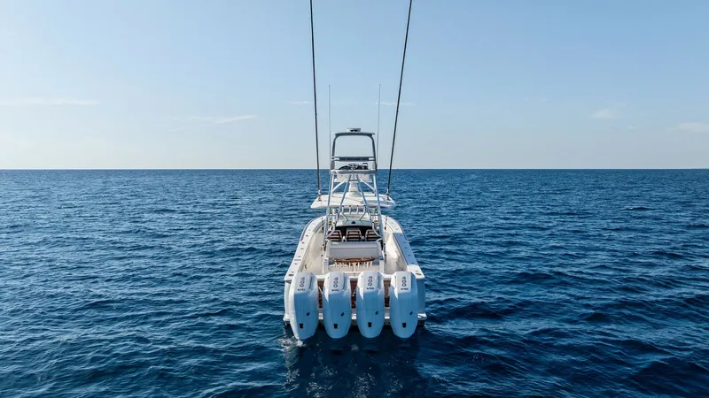 Slide: The Image of Stern View with Quad Engines This image showcases the stern of the 2025 Valhalla V-41, featuring an impressive quad-engine setup for superior performance. The spacious aft deck is designed for both leisure and functionality, offering ample seating and access to the water. The sleek l - 7517275