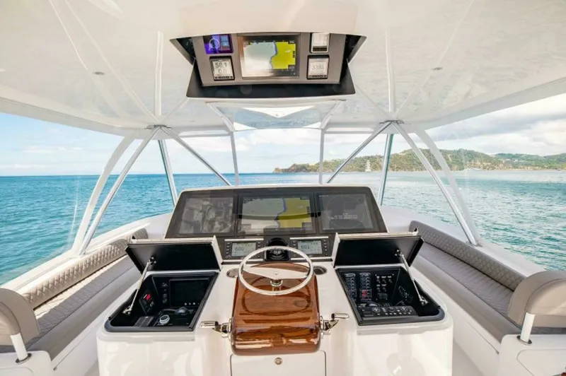 Slide: The Image of Flybridge Helm Station The flybridge of the 2023 Viking 64 Convertible features a state-of-the-art helm station with cutting-edge navigation technology. The spacious layout offers comfortable seating and clear visibility, ensuring an exceptional driving experience. Finished wit - 7530823
