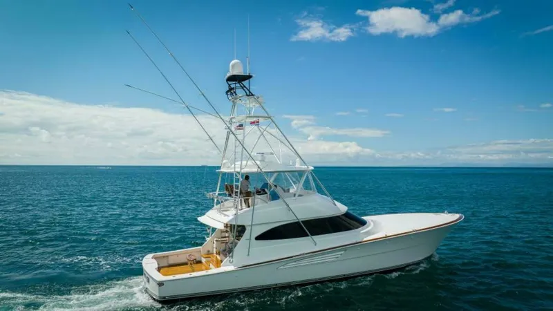 Slide: The Image of Profile View of Viking 64 Convertible This image showcases the sleek profile of the 2023 Viking 64 Convertible, highlighting its streamlined hull and elegant tower. The spacious aft deck is designed for both relaxation and sportfishing, featuring ample seating and state-of-the-art equipment. - 7530884