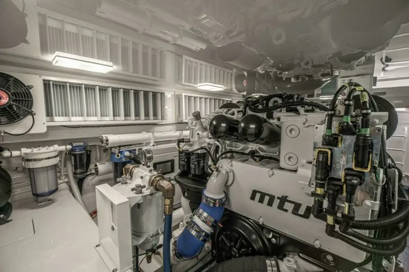 Slide: The Image of Engine Room with MTU Engines This image showcases the state-of-the-art engine room of the 2023 Viking 64 Convertible, featuring powerful MTU engines. The space is meticulously organized, with high-quality components and advanced engineering for optimal performance. Bright lighting an - 7530880