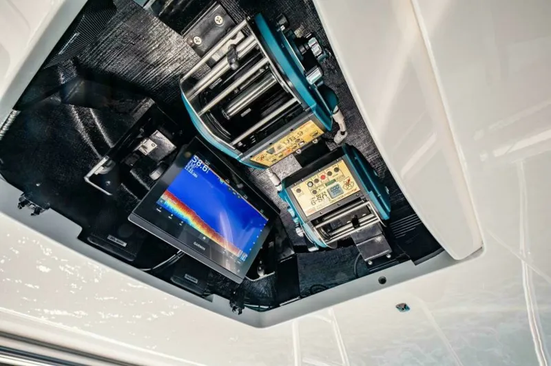 Slide: The Image of Overhead Electronics Console The Viking 64 Convertible features a state-of-the-art overhead electronics console, showcasing advanced navigation and control systems. This sleek setup includes multifunction displays and controls, designed for optimal accessibility and efficiency. The m - 7530865