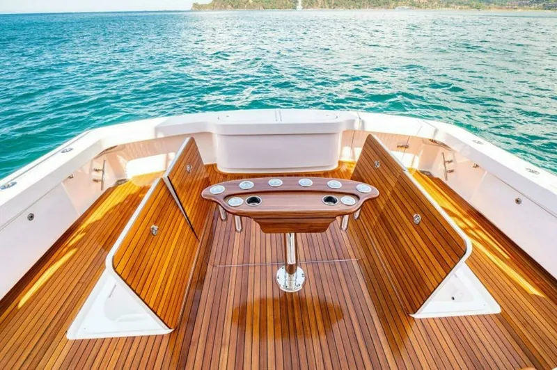 Slide: The Image of Spacious Aft Deck with Teak Finishes The aft deck of the 2023 Viking 64 Convertible offers a luxurious space with beautifully crafted teak flooring and ample seating. Its centerpiece is a well-designed, functional bait prep station, ideal for fishing enthusiasts. The open layout provides uno - 7530825
