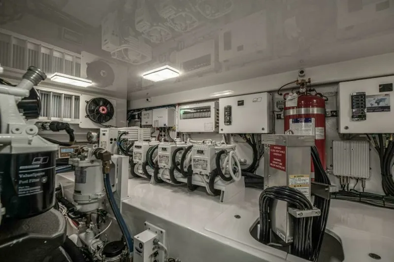 Slide: The Image of Engine Room with Advanced Systems The engine room of the 2023 Viking 64 Convertible showcases state-of-the-art systems and meticulous organization. Featuring advanced control panels and neatly arranged wiring, this space is designed for optimal functionality and ease of maintenance. The w - 7530879