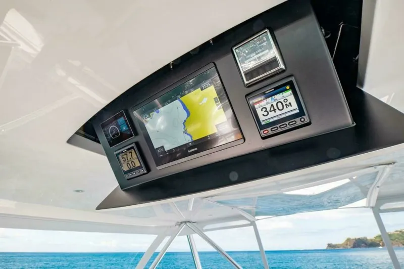 Slide: The Image of Flybridge Electronics Console The 2023 Viking 64 Convertible features a state-of-the-art flybridge electronics console, showcasing advanced navigation and monitoring systems. The integrated displays provide crucial data for safe and efficient travel, including maps and performance met - 7530864