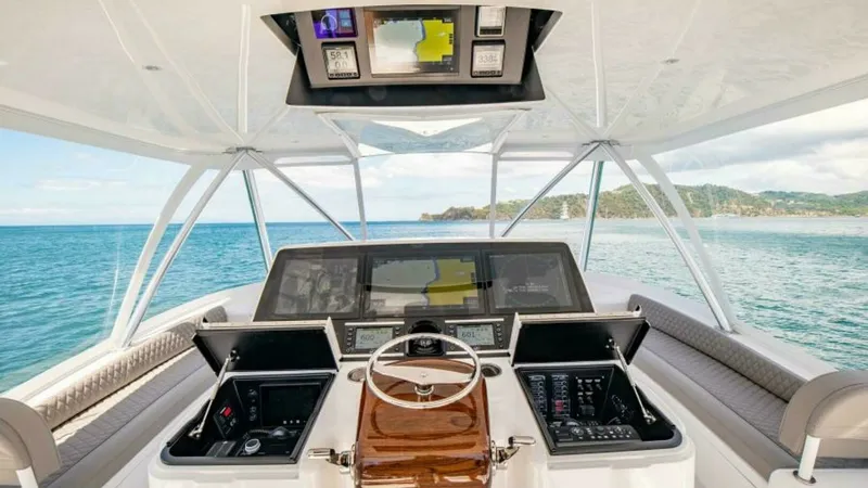 Slide: The Image of Flybridge Helm Station The flybridge of the 2023 Viking 64 Convertible features a state-of-the-art helm station with cutting-edge navigation technology. The spacious layout offers comfortable seating and clear visibility, ensuring an exceptional driving experience. Finished wit - 7600505