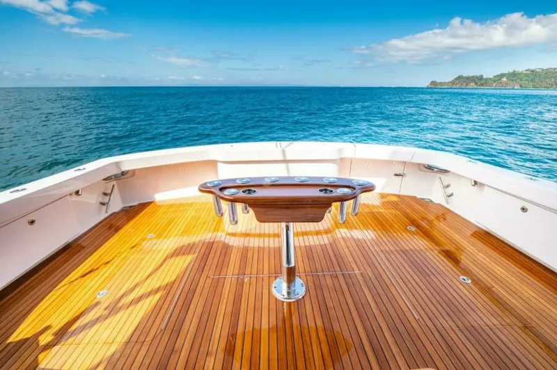 Slide: The Image of Spacious Aft Deck with Fishing Station This elegant aft deck on the 2023 Viking 64 Convertible, 'Twin Reels,' features a beautifully finished teak floor and a state-of-the-art fishing station. The ample space allows for both relaxation and efficient fishing, with stunning panoramic views of th - 7530874