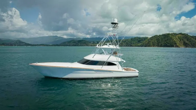 Slide: The Image of Starboard Side Profile in Open Waters The 2023 Viking 64 Convertible 'Twin Reels' is showcased in a stunning side profile, highlighting its sleek lines and robust structure. The yacht's expansive flybridge and aft cockpit are visible, designed for both performance and leisure. Set against a p - 7600563