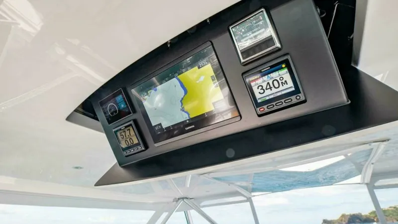 Slide: The Image of Flybridge Electronics Console The 2023 Viking 64 Convertible features a state-of-the-art flybridge electronics console, showcasing advanced navigation and monitoring systems. The integrated displays provide crucial data for safe and efficient travel, including maps and performance met - 7600546