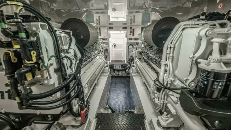Slide: The Image of Engine Room with Twin Engines This image showcases the immaculate engine room of the 2023 Viking 64 Convertible, featuring powerful twin engines. The space is designed for optimal performance and accessibility, with a clean, organized layout and high-quality engineering. The metallic - 7600559