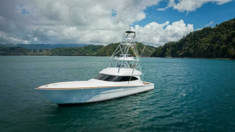 Slide: The Image of Bow View of Viking 64 Convertible This image showcases the elegant bow of the 2023 Viking 64 Convertible, 'Twin Reels'. The sleek design is highlighted by smooth lines and a sturdy tower, perfect for spotting fish or enjoying panoramic views. Set against a picturesque backdrop, this vesse - 7530882