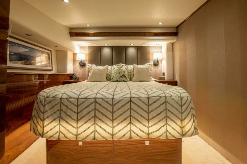 Slide: The Image of Luxurious Master Stateroom The master stateroom of the 2023 Viking 64 Convertible exudes elegance with its plush bedding and ambient lighting. Rich wood finishes and modern wall sconces enhance the luxurious atmosphere, while the spacious layout provides comfort and style. This inv - 7530826