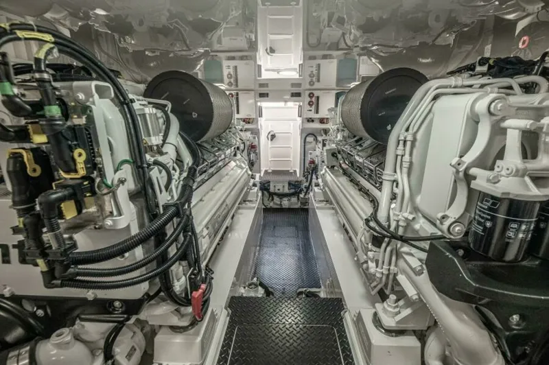 Slide: The Image of Engine Room with Twin Engines This image showcases the immaculate engine room of the 2023 Viking 64 Convertible, featuring powerful twin engines. The space is designed for optimal performance and accessibility, with a clean, organized layout and high-quality engineering. The metallic - 7530877