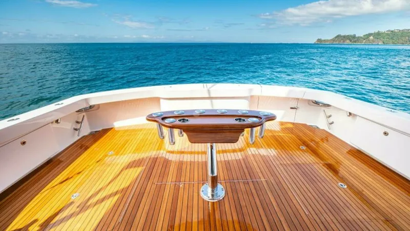 Slide: The Image of Spacious Aft Deck with Fishing Station This elegant aft deck on the 2023 Viking 64 Convertible, 'Twin Reels,' features a beautifully finished teak floor and a state-of-the-art fishing station. The ample space allows for both relaxation and efficient fishing, with stunning panoramic views of th - 7600556