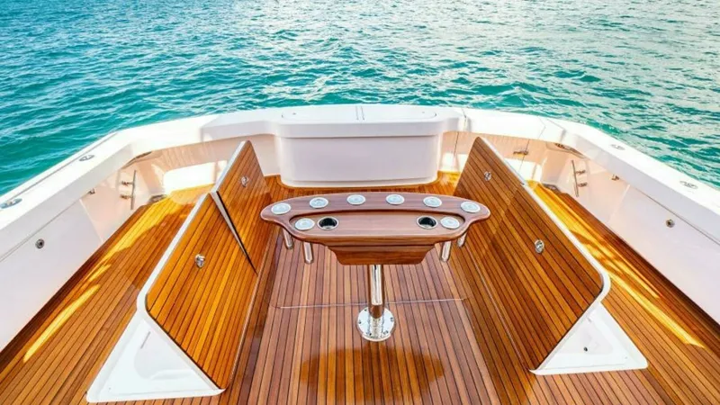 Slide: The Image of Spacious Aft Deck with Teak Finishes The aft deck of the 2023 Viking 64 Convertible offers a luxurious space with beautifully crafted teak flooring and ample seating. Its centerpiece is a well-designed, functional bait prep station, ideal for fishing enthusiasts. The open layout provides uno - 7600507