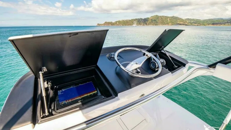 Slide: The Image of Flybridge Helm Station with Electronics The flybridge helm station of the 2023 Viking 64 Convertible offers a commanding view with state-of-the-art navigation systems. Featuring dual electronic displays and a sleek steering wheel, the helm is designed for optimal control and comfort. The open-a - 7600551