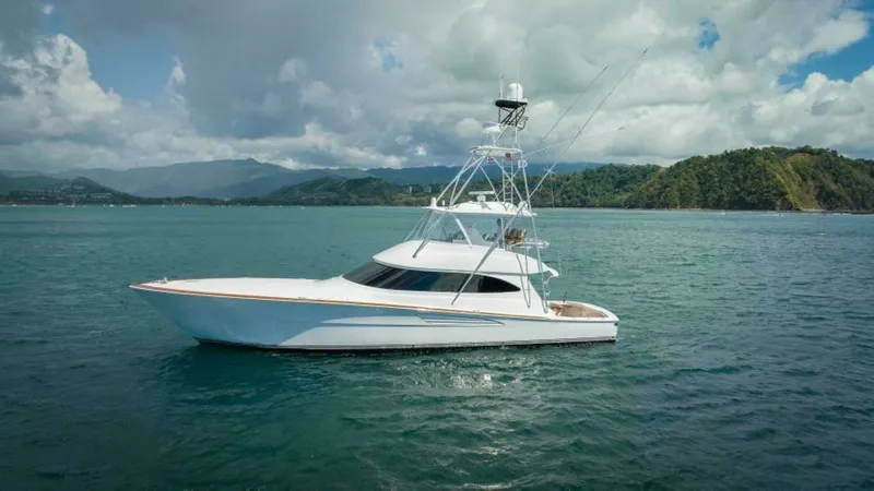 Slide: The Image of Starboard Side Profile in Open Waters The 2023 Viking 64 Convertible 'Twin Reels' is showcased in a stunning side profile, highlighting its sleek lines and robust structure. The yacht's expansive flybridge and aft cockpit are visible, designed for both performance and leisure. Set against a p - 7530881