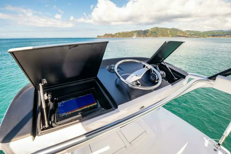 Slide: The Image of Flybridge Helm Station with Electronics The flybridge helm station of the 2023 Viking 64 Convertible offers a commanding view with state-of-the-art navigation systems. Featuring dual electronic displays and a sleek steering wheel, the helm is designed for optimal control and comfort. The open-a - 7530869