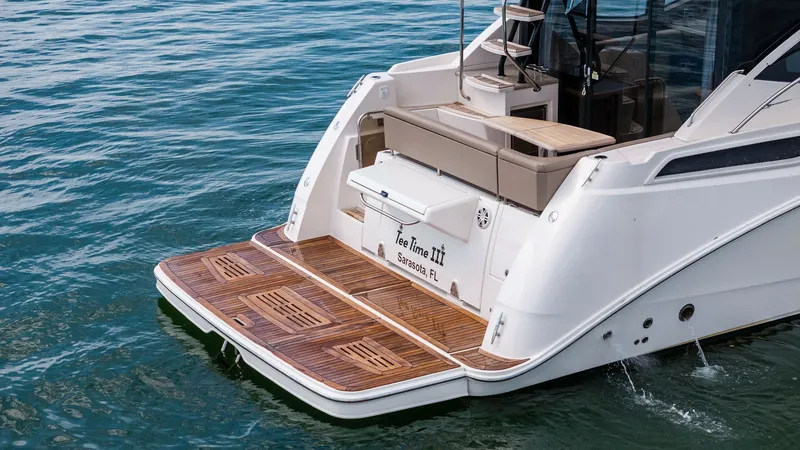 Slide: The Image of Spacious Aft Deck with Swim Platform The 2018 Sea Ray 400 Fly features a luxurious aft deck with a beautifully finished teak swim platform, perfect for easy water access. The seating area offers comfortable lounging with sleek design elements, creating an inviting outdoor space for relaxatio - 7762729
