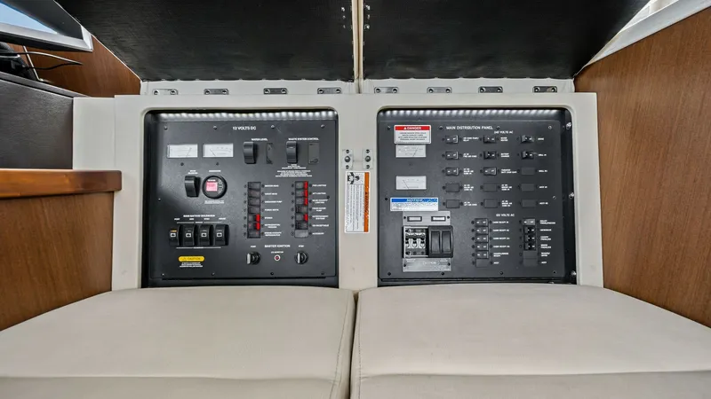 Slide: The Image of Electrical Control Panel This image showcases the comprehensive electrical control panel of the 2018 Sea Ray 400 Fly, featuring clearly labeled switches and controls for easy navigation. The panel is strategically located for accessibility and offers a sleek, organized design. Hi - 7762698