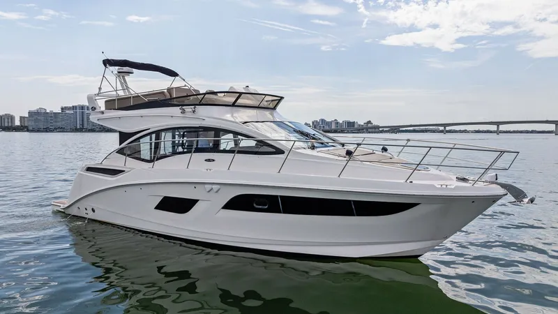 Slide: The Image of Starboard View of Sea Ray 400 Fly The 2018 Sea Ray 400 Fly, Tee Time III, showcases sleek lines and a modern design in this starboard view. With expansive windows and a flybridge, this vessel offers excellent visibility and ample outdoor space. Perfect for cruising, its elegant profile an - 7762730