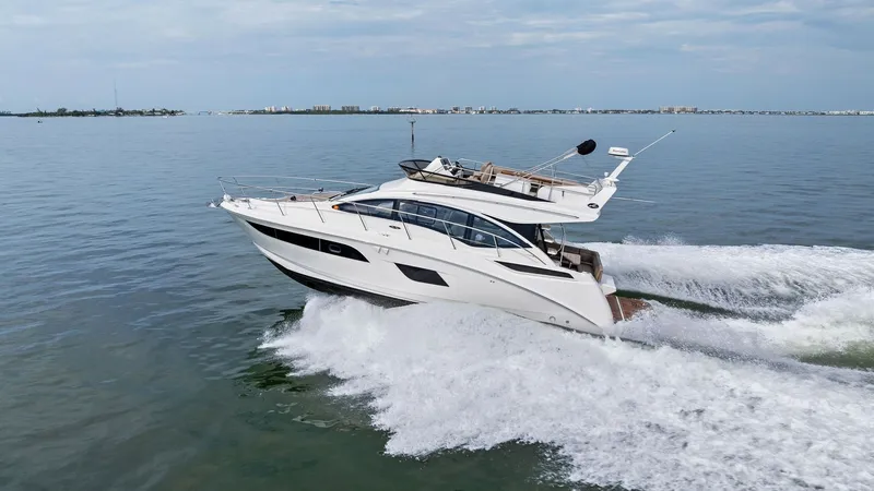Slide: The Image of Dynamic Side View at Sea This image captures the sleek profile of the 2018 Sea Ray 400 Fly, Tee Time III, gliding effortlessly across open waters. The vessel showcases its elegant lines and sophisticated design, with a spacious flybridge offering panoramic views. The aerodynamic - 7762734