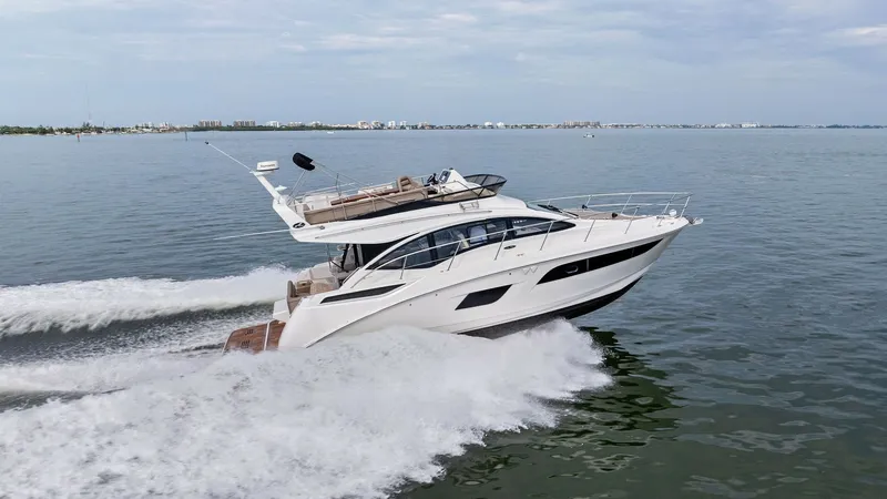 Slide: The Image of Dynamic Starboard Profile in Motion This stunning profile view of the 2018 Sea Ray 400 Fly showcases its sleek lines and modern design as it cruises effortlessly through the water. The flybridge offers ample seating, perfect for enjoying panoramic views, while the expansive windows flood th - 7762735