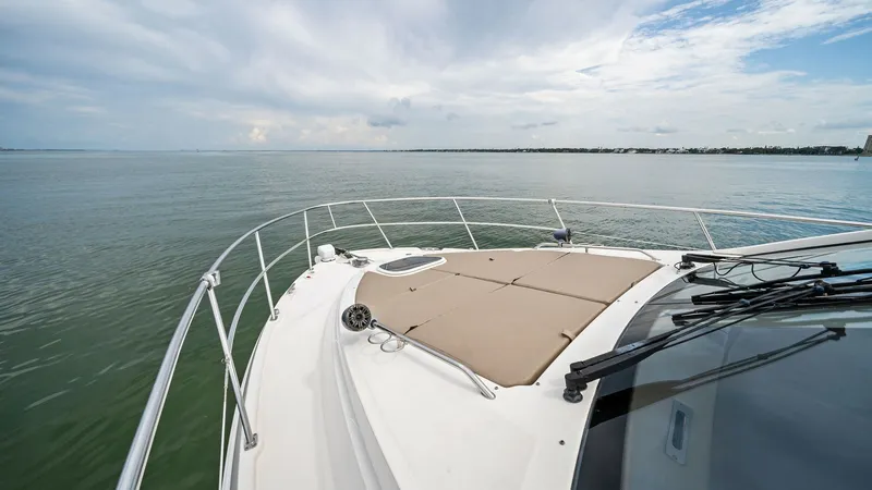 Slide: The Image of Spacious Bow with Sunpad The bow of the 2018 Sea Ray 400 Fly, Tee Time III, features an expansive sunpad area perfect for relaxation. With sleek railings and a panoramic view of the water, this space combines comfort and style. Enjoy the serene environment and ample space for sun - 7762747