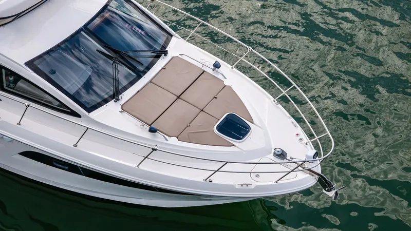 Slide: The Image of Bow Sunpad and Rails The bow of the 2018 Sea Ray 400 Fly features a spacious sunpad, perfect for lounging and enjoying the open water views. Stainless steel rails provide safety and a sleek look, while the large deck hatch offers easy access to the cabin below. The combinatio - 7762728