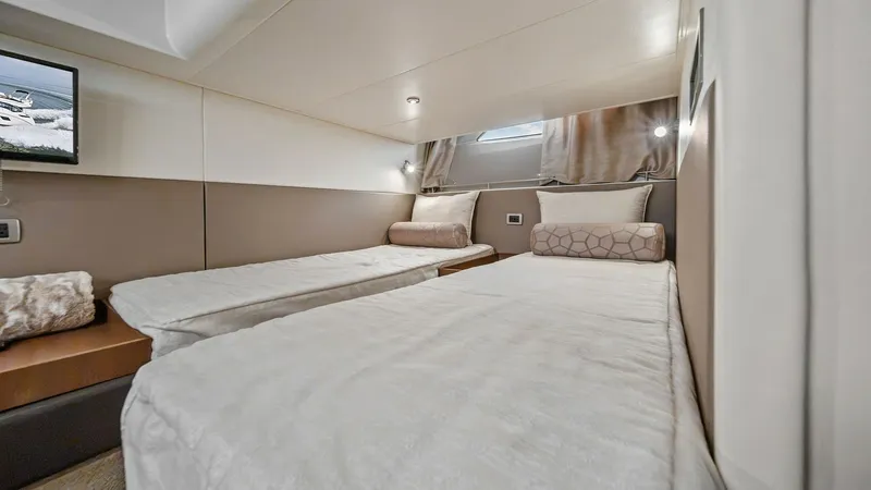 Slide: The Image of Twin Guest Stateroom The twin guest stateroom on the 2018 Sea Ray 400 Fly offers a serene retreat with its two comfortable single beds. The space is elegantly designed with soft, neutral tones and features a window for natural light. This well-appointed cabin ensures a restfu - 7762706