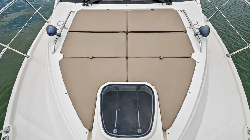 Slide: The Image of Spacious Forward Sunpad Lounge The forward deck of the 2018 Sea Ray 400 Fly features an expansive sunpad, offering a luxurious space for relaxation. The durable, weather-resistant cushions are tailored for comfort and style, perfectly complementing the sleek lines of the vessel. An int - 7762751