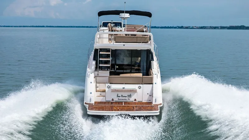 Slide: The Image of Aft View with Swim Platform The 2018 Sea Ray 400 Fly, Tee Time III, showcases its elegant aft design with a spacious swim platform perfect for water activities. The aft deck features comfortable seating, providing a perfect spot for relaxation while enjoying the open water. The flyb - 7762742