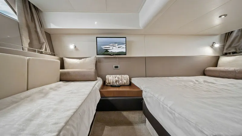 Slide: The Image of Twin Guest Stateroom This inviting twin guest stateroom on the 2018 Sea Ray 400 Fly offers comfort and style. The room features two spacious beds with plush bedding and ambient lighting, complemented by a modern wall-mounted artwork. Neutral tones and elegant finishes create - 7762710