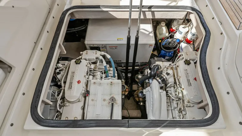 Slide: The Image of Engine Compartment View This image showcases the well-maintained engine compartment of the 2018 Sea Ray 400 Fly, Tee Time III. The layout features dual engines, offering reliable performance and efficiency. The space is organized for easy access to components, emphasizing the ve - 7762717