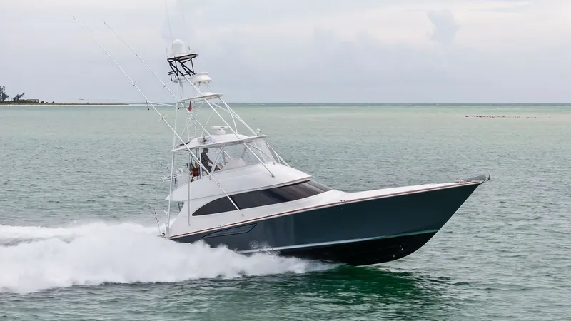 Slide: The Image of Viking 55 Convertible at Sea The Viking 55 Convertible glides effortlessly through the water, showcasing its sleek lines and powerful performance. The vessel's elegant design is complemented by a sturdy flybridge, offering excellent visibility and control. Built in 2015, this model e - 7584936
