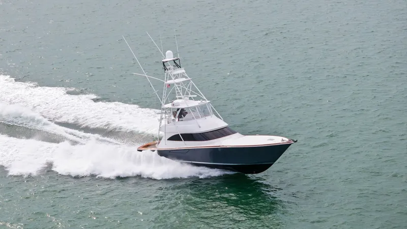 Slide: The Image of Aerial View of Viking 55 in Motion The 2015 Viking 55 Convertible, named Rosita, is captured here cutting through the water with impressive speed and grace. The sleek hull design and powerful engines create an exhilarating wake, showcasing the vessel's superior performance. This dynamic vi - 7584947