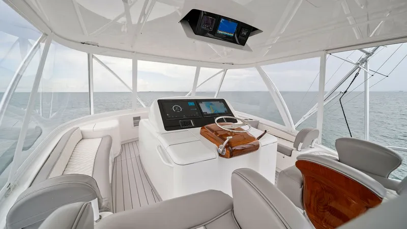 Slide: The Image of Flybridge Helm with Seating The flybridge of the 2015 Viking 55 Convertible offers a commanding helm station with state-of-the-art navigation systems. Plush seating surrounds the helm, providing comfort for guests while enjoying panoramic ocean views. The elegantly finished wood acc - 7584895