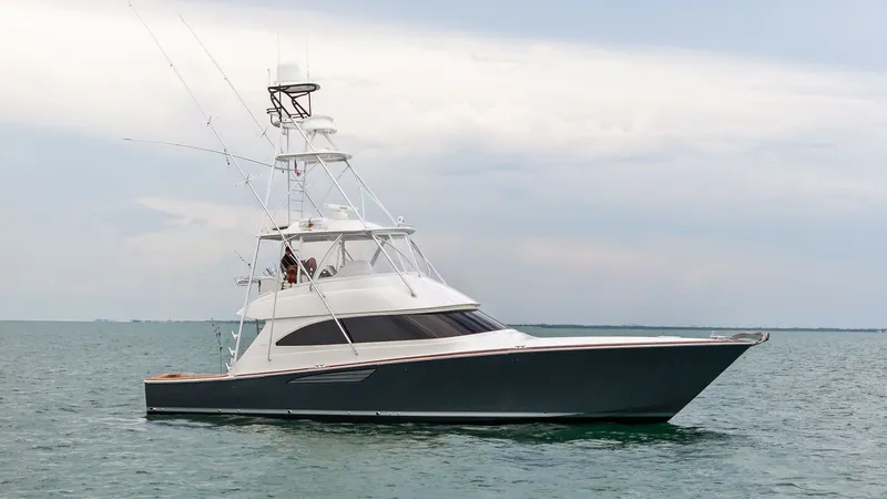 Slide: The Image of Profile View of Viking 55 Convertible The 2015 Viking 55 Convertible 'Rosita' is showcased in a sleek profile view, emphasizing its elegant lines and robust build. The vessel features a flybridge with a well-equipped tower, offering excellent visibility and control for fishing or cruising. It - 7584929