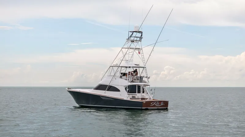 Slide: The Image of Starboard Side View with Tower The Viking 55 Convertible, 'Rosita', showcases its sleek design and robust fishing capabilities. The starboard side view highlights the impressive tuna tower, ideal for spotting game fish. With smooth lines and a commanding presence, this vessel is built - 7584921