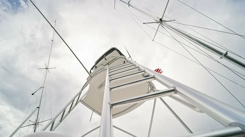 Slide: The Image of Tower and Outriggers The image showcases the sleek tower and outriggers of the 2015 Viking 55 Convertible, 'Rosita'. The robust ladder leads up to the tower, offering a commanding view of the surroundings. Crafted with durable materials, the structure ensures stability and fu - 7584903