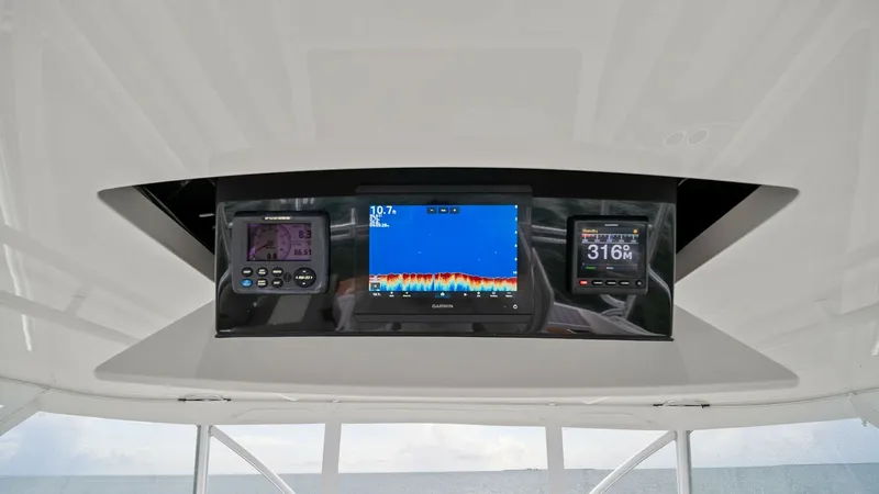 Slide: The Image of Flybridge Electronics Display The Viking 55 Convertible's flybridge features a state-of-the-art electronics display, including multi-function displays for navigation and fish-finding. The sleek, integrated design ensures easy access and visibility, enhancing the captain's control and - 7584905