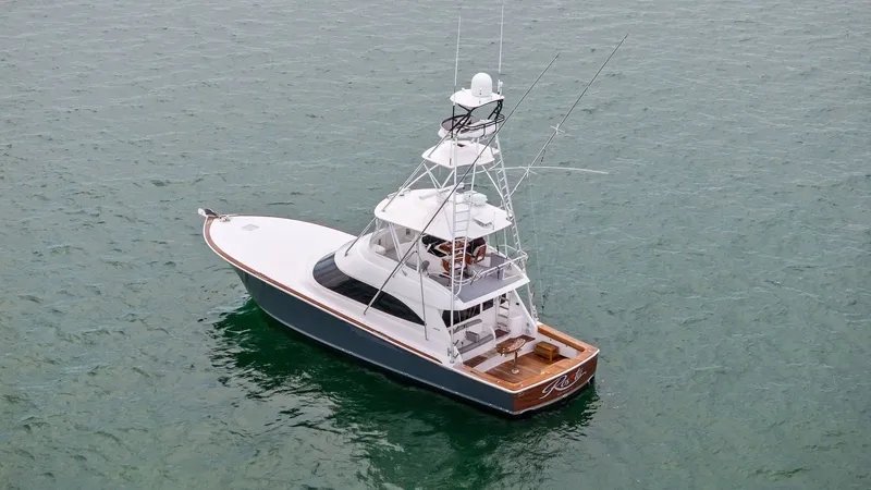 Slide: The Image of Aerial View of Flybridge and Deck This aerial shot showcases the Viking 55 Convertible's sleek design and spacious flybridge, complete with an elevated helm station and seating area. The vessel's aft deck is visible, featuring a large cockpit ideal for fishing and entertaining. The elegan - 7584922